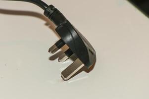 black plug from English standard socket on the table 3 photo