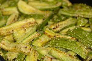 baked zucchini cut into sticks with sesame seeds cooked in the oven photo