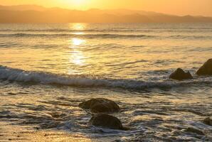 stones in the Mediterranean sea in the evening at sunset 2 photo