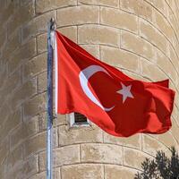 Turkish flag on the background of a brick wall of the mosque 2 photo