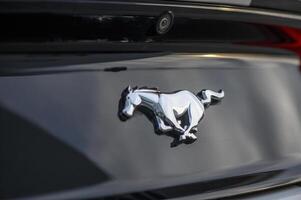 02.29.2024 Gazeveren Cyprus - Ford Mustang emblem on a black trunk lid 1 photo