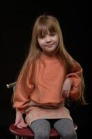 studio portrait of a charming little girl on a black background 1 photo