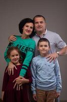 studio portrait of a happy family husband wife daughter and son 10 photo