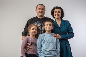 studio portrait of a happy family husband wife daughter and son 2 photo