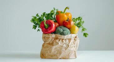 Brown Paper Bag Filled With Fresh Produce on White Background photo