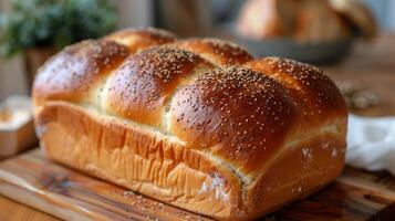 Freshly Baked Loaf of Bread on Wooden Cutting Board photo