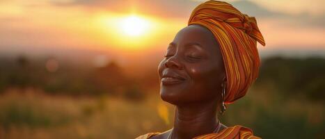 Woman In Headscarf Smiles At Sunset In Africa photo