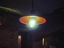 retro vintage lamp in cafe interior, bar or restaurant with brick walls background. photo