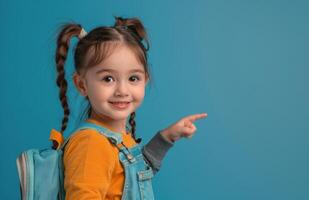 Young Girl With Braids Points to the Side While Wearing a Backpack photo