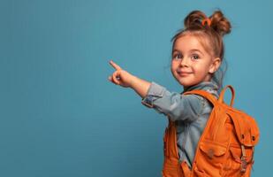 Young Girl With Backpack Points Right on Blue Background photo