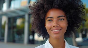 Portrait of a Smiling Woman With Curly Hair in a City Setting photo