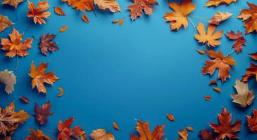 Autumn Leaves Frame on Blue Background photo