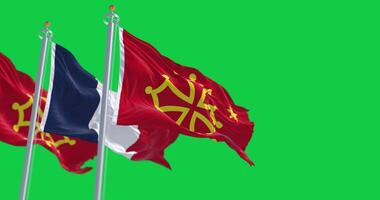 Flags of Occitanie region and France waving isolated on green background video