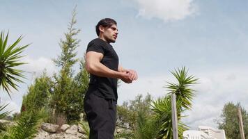 Young Guy Bodybuilder Bulks Biceps Muscle In The Mountains video