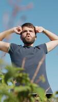 Young Man Opens And Closes His Elbows For Gym In The Park video