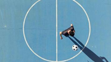 pojke spelar freestyle fotboll med boll över huvudet se i de fält video