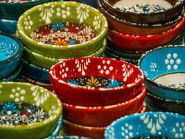 Array of handmade uniquely designed porcelain plates, focused on red plates photo