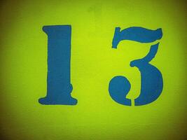 number thirteen painted on yellow wall with vignette photo