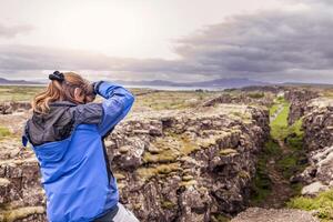 female nature photographer in action photo