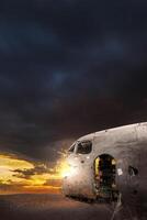 wreck of a white airplane on the black beach photo