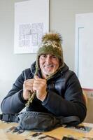 portrait of middle aged man posing sitting wearing a typical icelandic wool hat photo