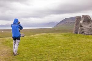 female nature photographer in action in the wild landscape photo