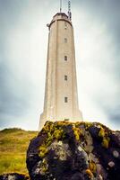 White lighthouse on the extreme west coast of Iceland. photo