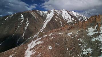 Mountain ranges with snowy peaks view drone video
