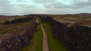 man walking Thingvellir National Park Iceland drone video