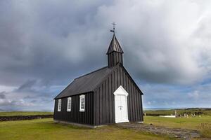 the famous black church of Budir in Iceland photo