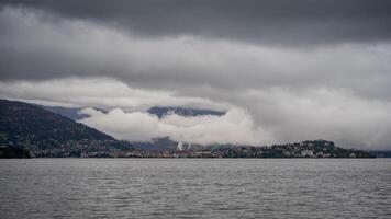 panorama of lake Maggiore on a rainy day with heavy low clouds covering part of the coast photo