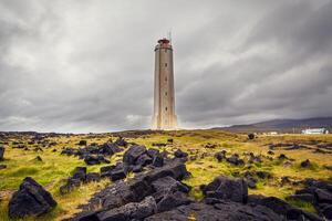 White lighthouse on the extreme west coast of Iceland. photo