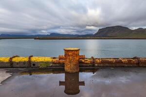 oxidado hierro noray para fondeo buques en un islandés muelle foto