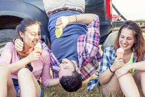 group of young adults make crazy and eat the ice cream photo