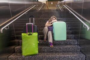 tired tourist traveler waiting sitting on the stairs photo