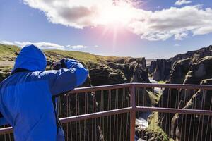 female nature photographer in action in the wild landscape photo