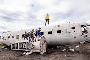 group of friends having fun walking over a plane photo