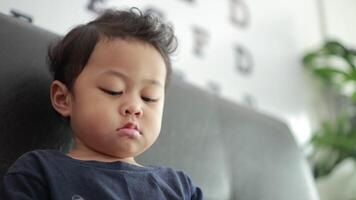 Portrait of children on sofa in home video