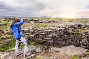 female nature photographer in action photo