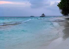 Maldive sunset landscape, coast line with resort photo