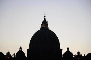 Vatican and St. Peter's Basilica Cupola in the Sunset Silhouette photo