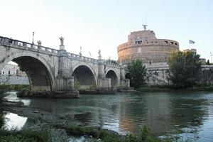 Rome, Italy - September 13 2022 Ponte Sant'Angelo Castel or Castello Angelo and the Tiberis or Tevere River with Bridge in Rome, Italy photo