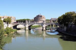 Rome, Italy - September 13 2022 Vittorio Emanuele II Bridge and Sant'Angelo Castel or Castello Angelo in Rome, Italy with Boat photo