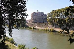 Rome, Italy - September 13 2022 Sant'Angelo Castel or Castello Angelo and the Tiberis or Tevere River in Rome, Italy photo