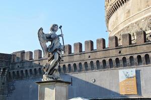 Angel Sculpture and Sant'Angelo Castel or Castello Angelo in Rome, Italy photo