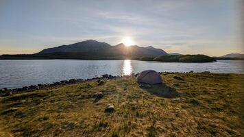 Camping tent by Lough Inagh, Connemara national park, county Galway, Ireland, lakeside landscape scenery with mountains in background, scenic nature wallpaper photo