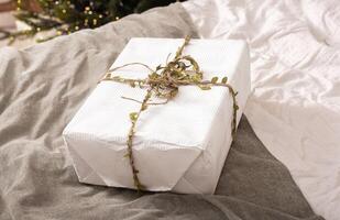 Christmas gift boxes wrapped in paper with twine string. Holiday presents, eco friendly, modern photo