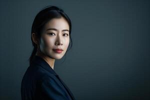 Portrait of elegant Asian businesswoman, smiling, standing on white background. Stylish, modern photo