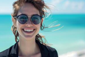 Young woman in sunglasses enjoying summer beach holiday. Smiling, fashionable, happy portrait photo