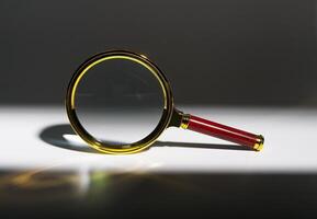 Intense business analysis, document search with magnifying glass. Market survey, financial audit, photo